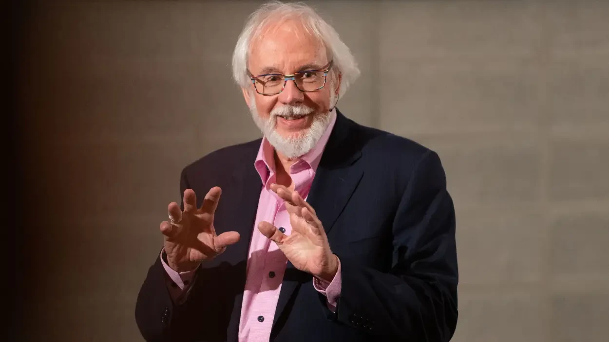 Bob smiling and gesturing with both hands at the Piet Sanders Lecture