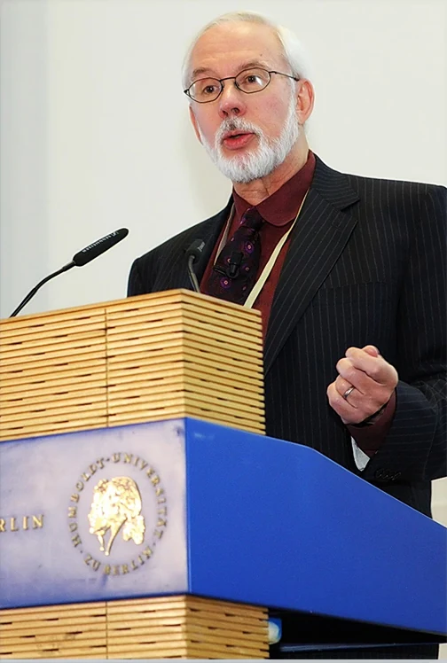 Robert G. Eccles speaking behind a wooden lectern